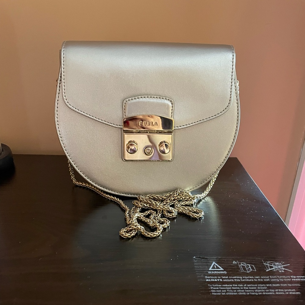 Furla round metropolis bag.  Golden color.